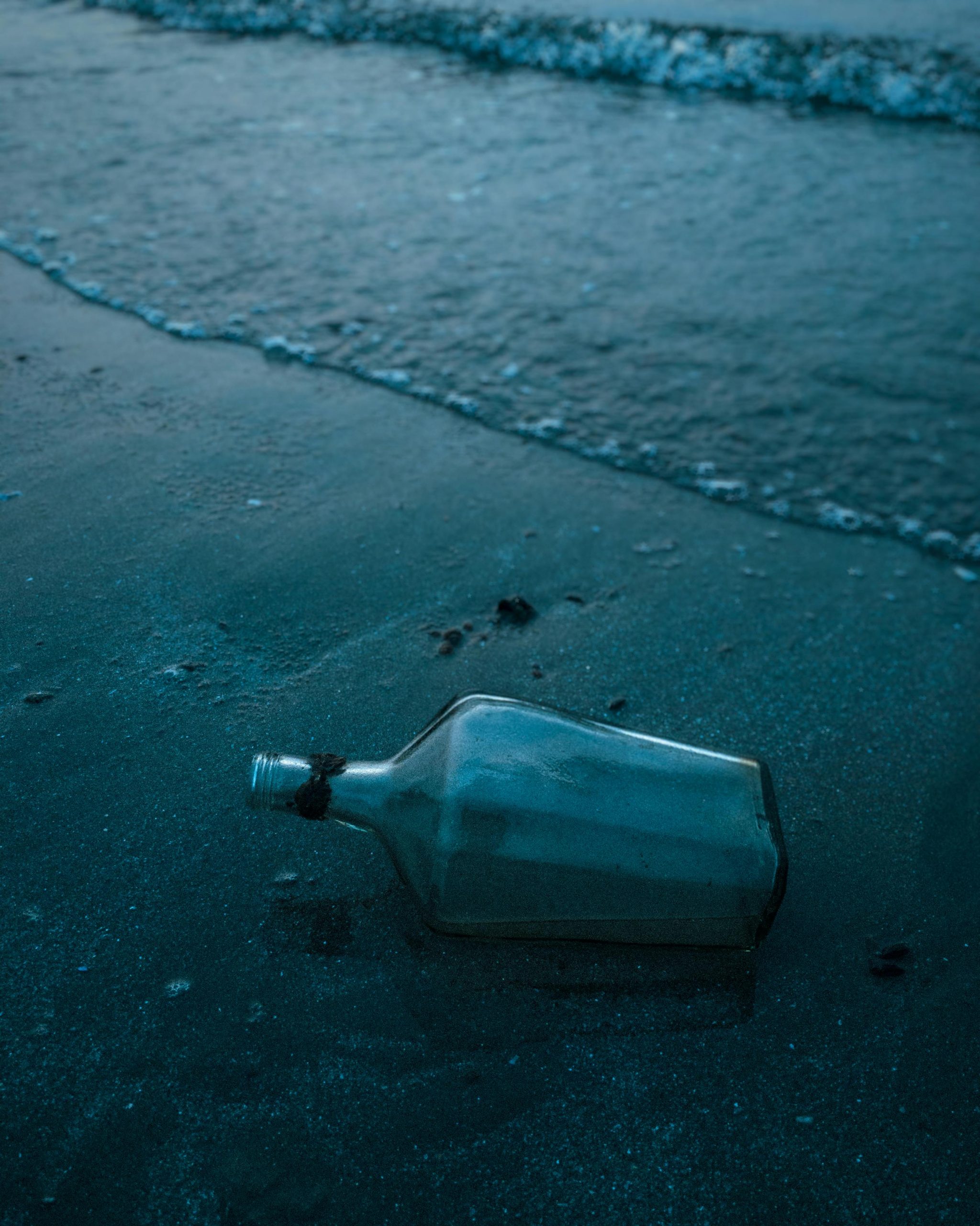 Clear Glass Bottle on Seashore